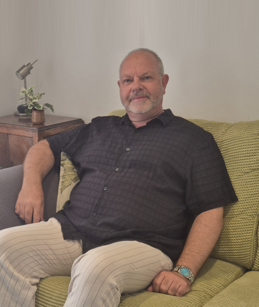 Portrait of Carl Lingwood, counsellor, seated in his therapy room