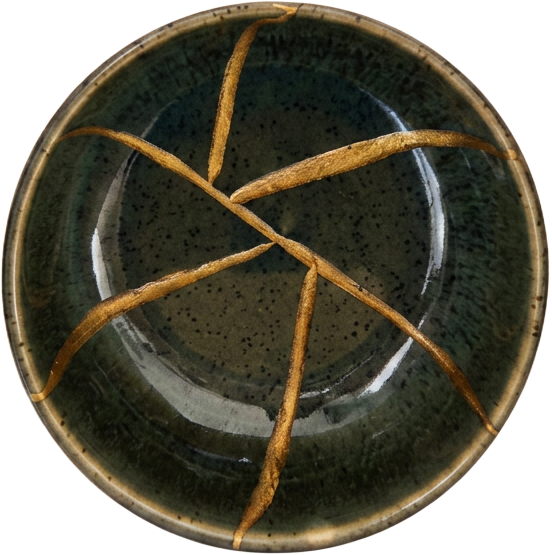 A kintsugi bowl repaired with gold lacquer along its cracks